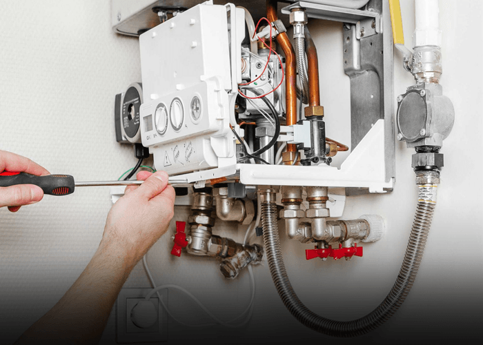 Engineer working on pipework for a new boiler in Sheffield property