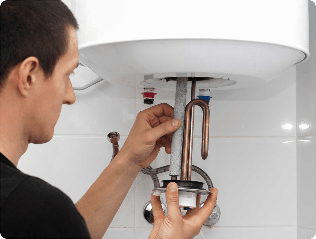 Plumber installing components beneath a new boiler in Sheffield